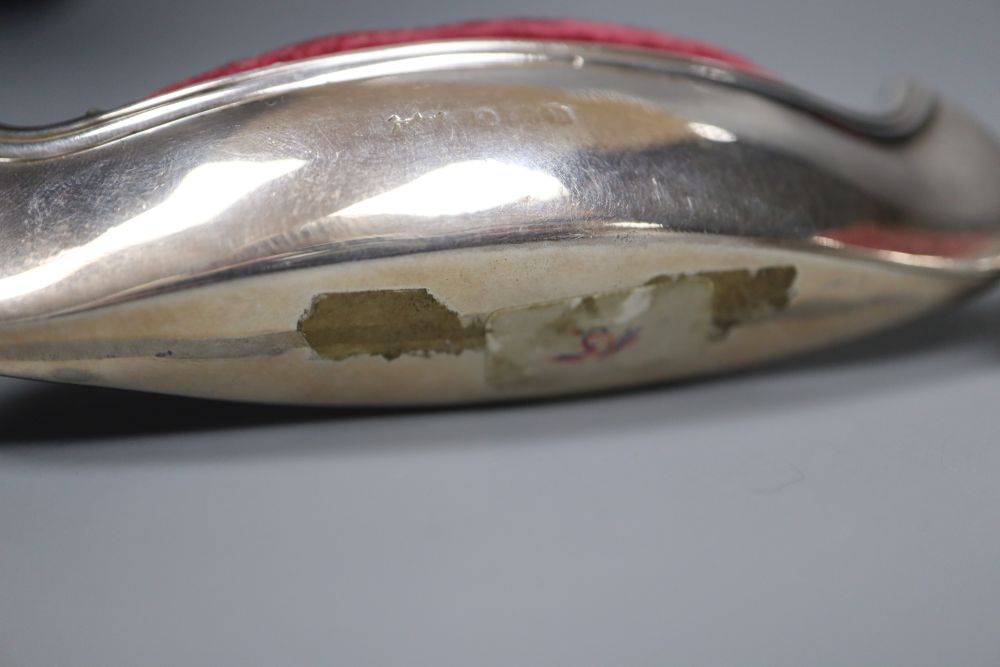 Two early 20th century novelty silver mounted pin cushions, canoe & clog, marks rubbed, canoe 9.5cm.